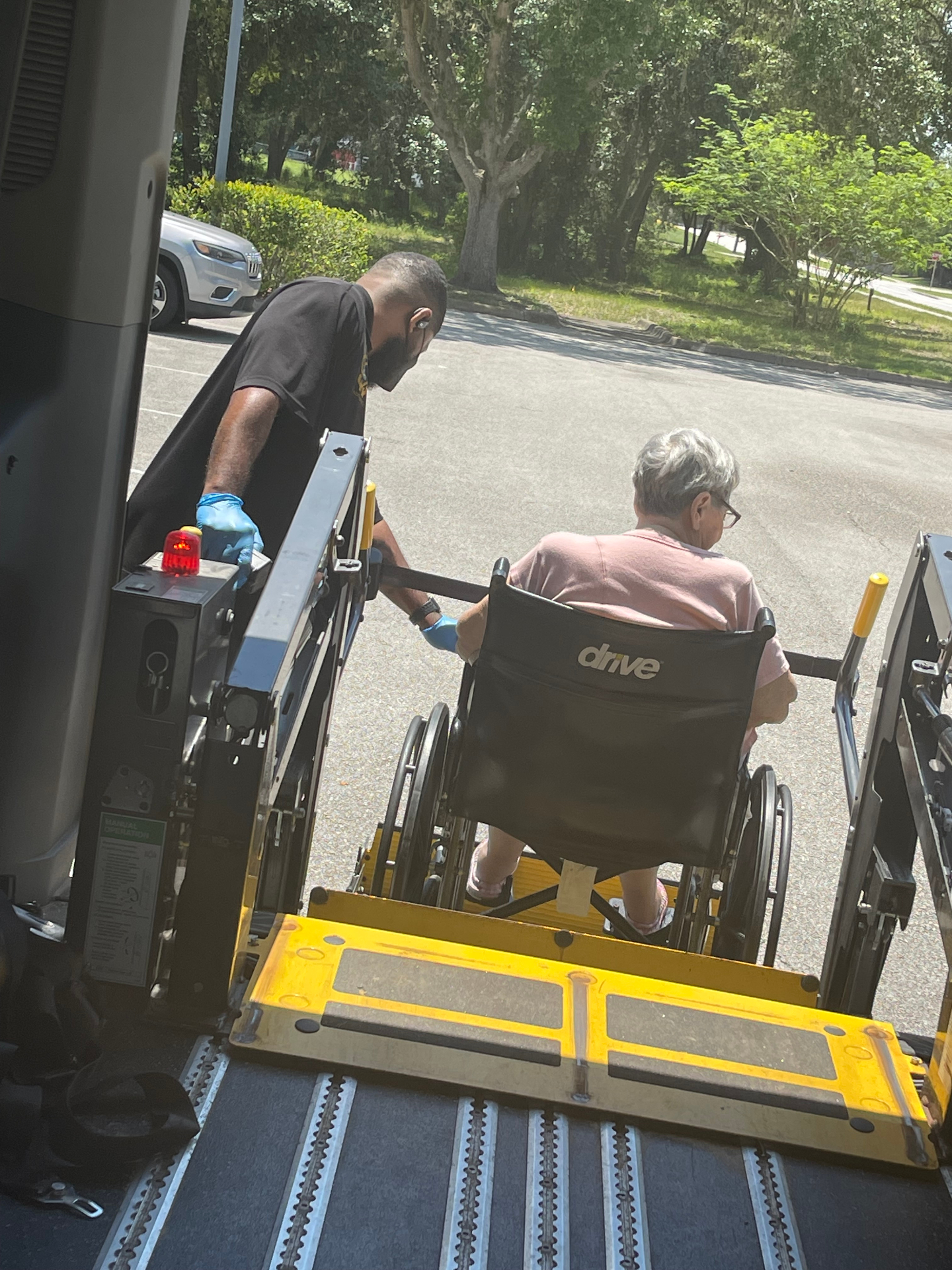 Wheelchair passenger being loaded on lift