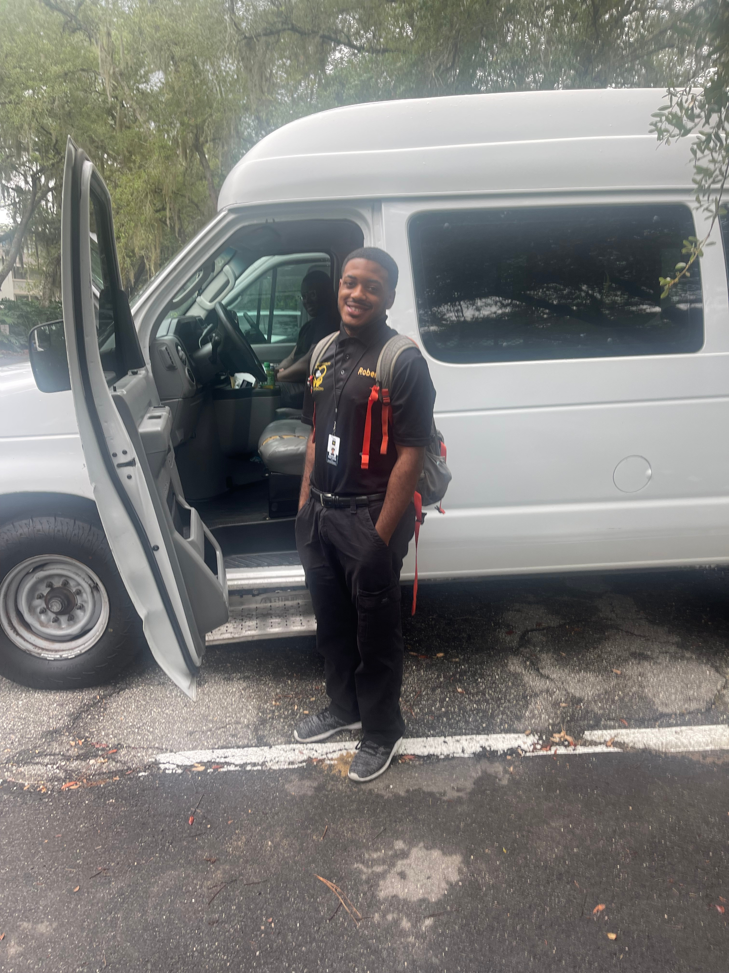 Uniformed driver ready beside the transport van